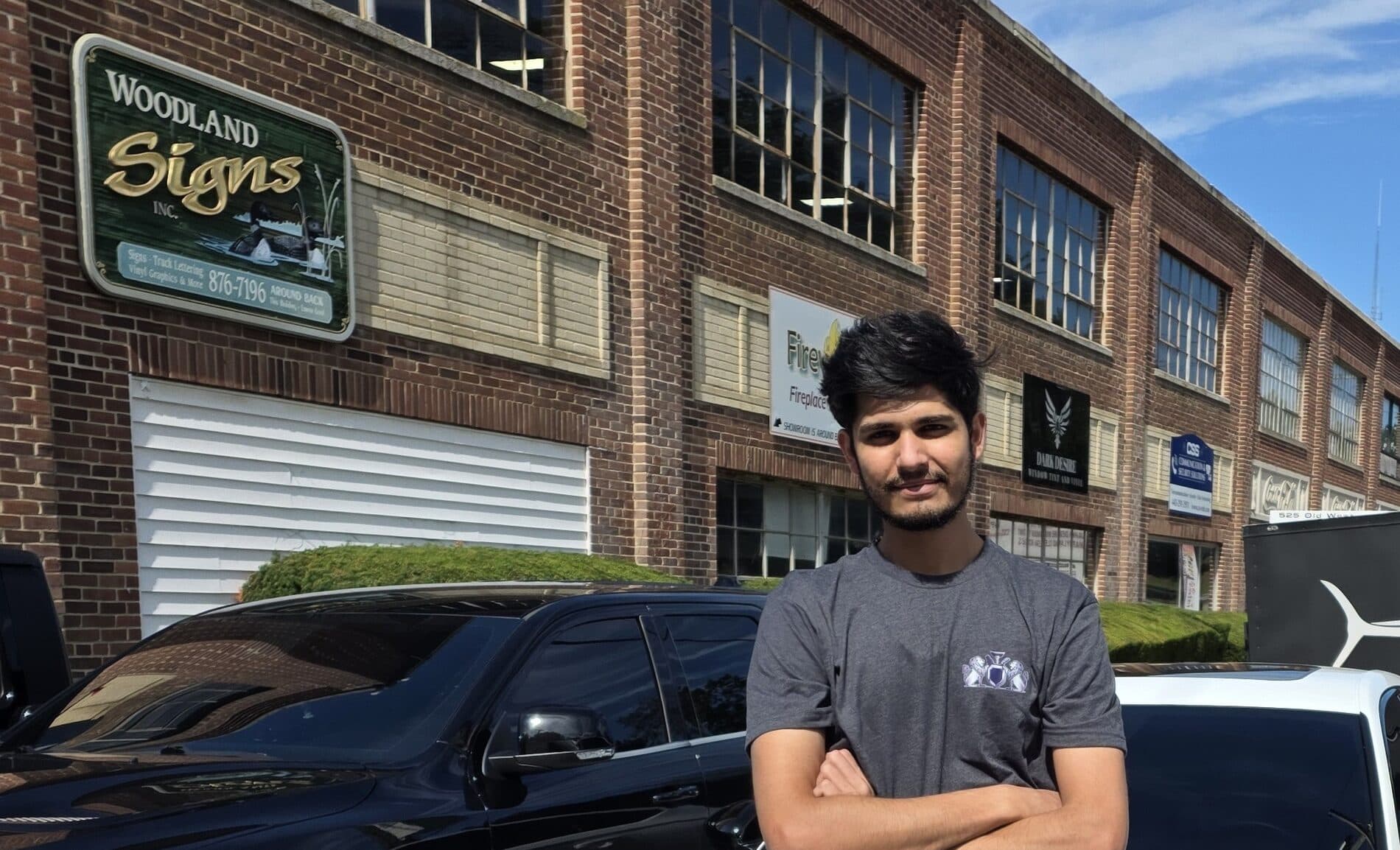 Mr. G, owner of Mr. G's Auto Care, standing with his freshly detailed white Honda outside the shop in Westminster, MD