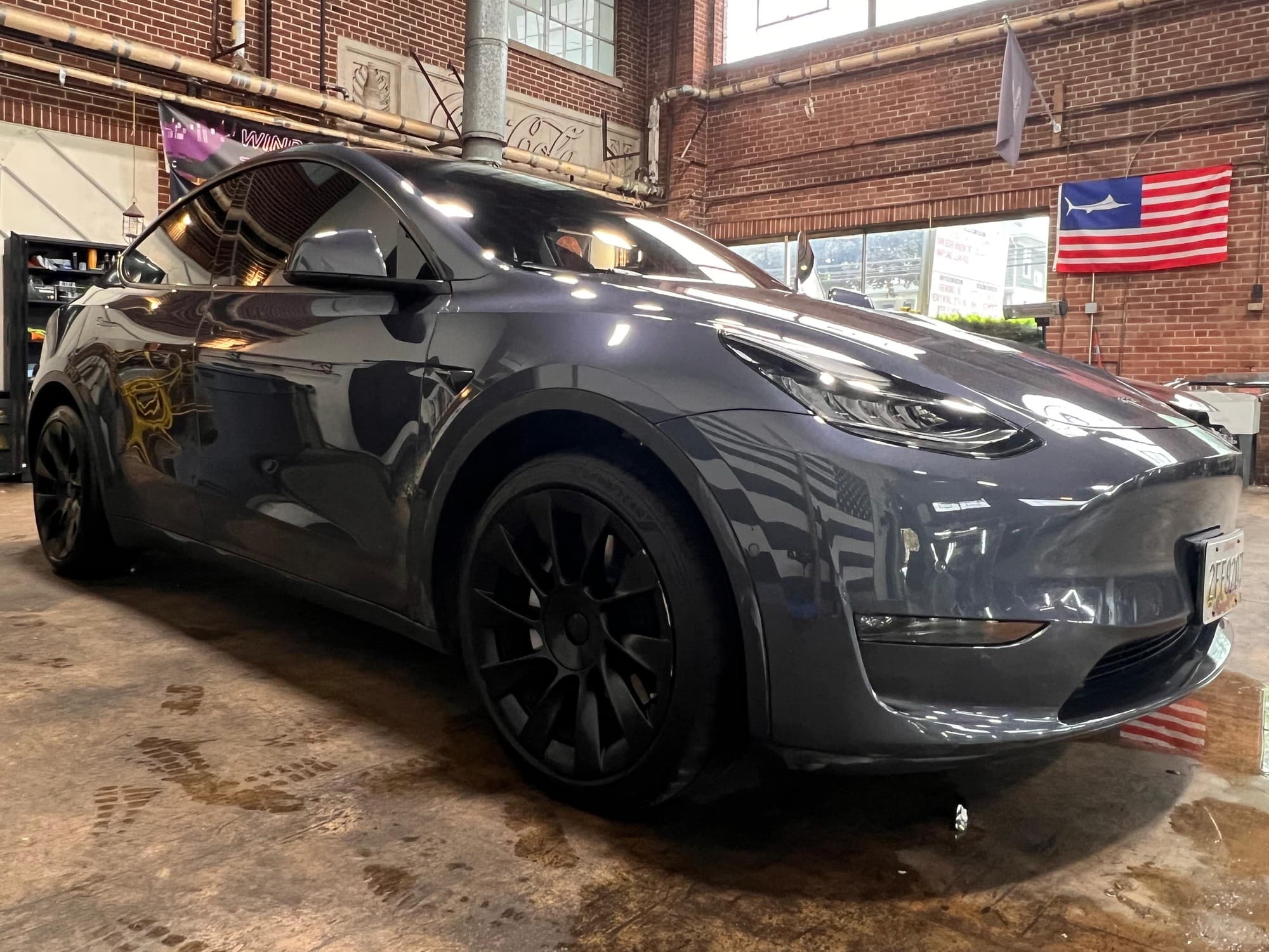 A dark Tesla Model Y detailed to a deep, reflective gloss in the Mr. G's Auto Care bay in Westminster, MD
